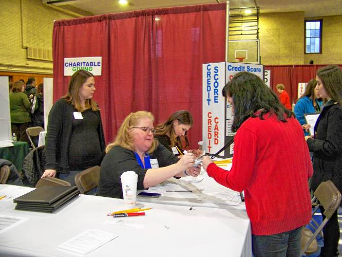 Credit for Life fair students learning about Credit Scores with Volunteers