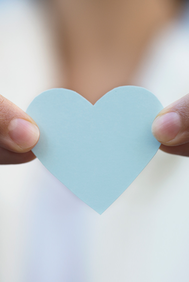 paper heart held between fingers